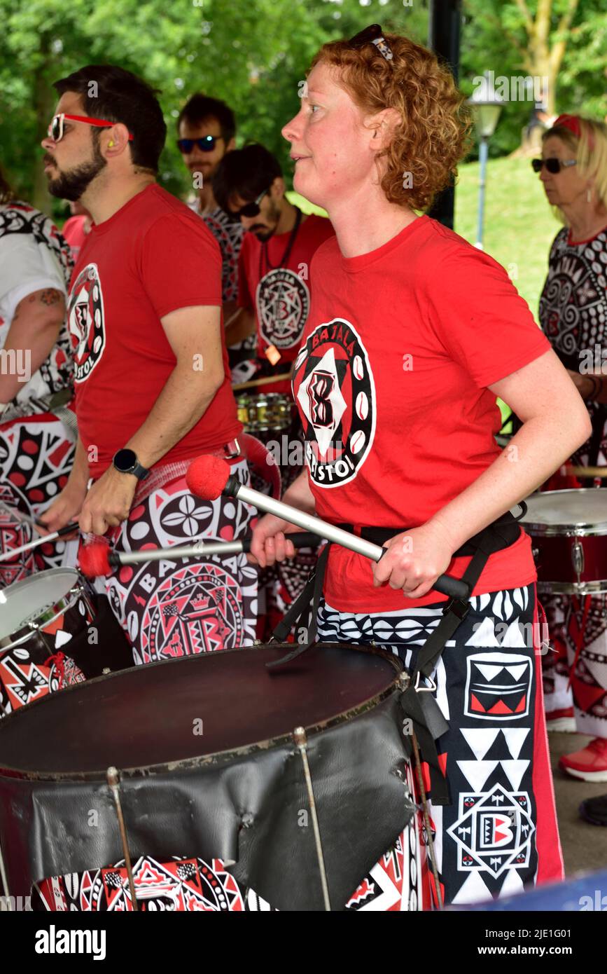 Woman in Batala drumming band performing in outdoor bandstand, Bristol, UK Stock Photo