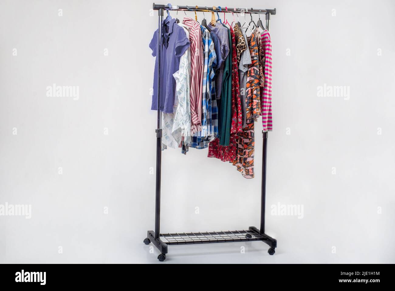 Various secondhand clothes from the wardrobe on the rack Stock Photo Alamy