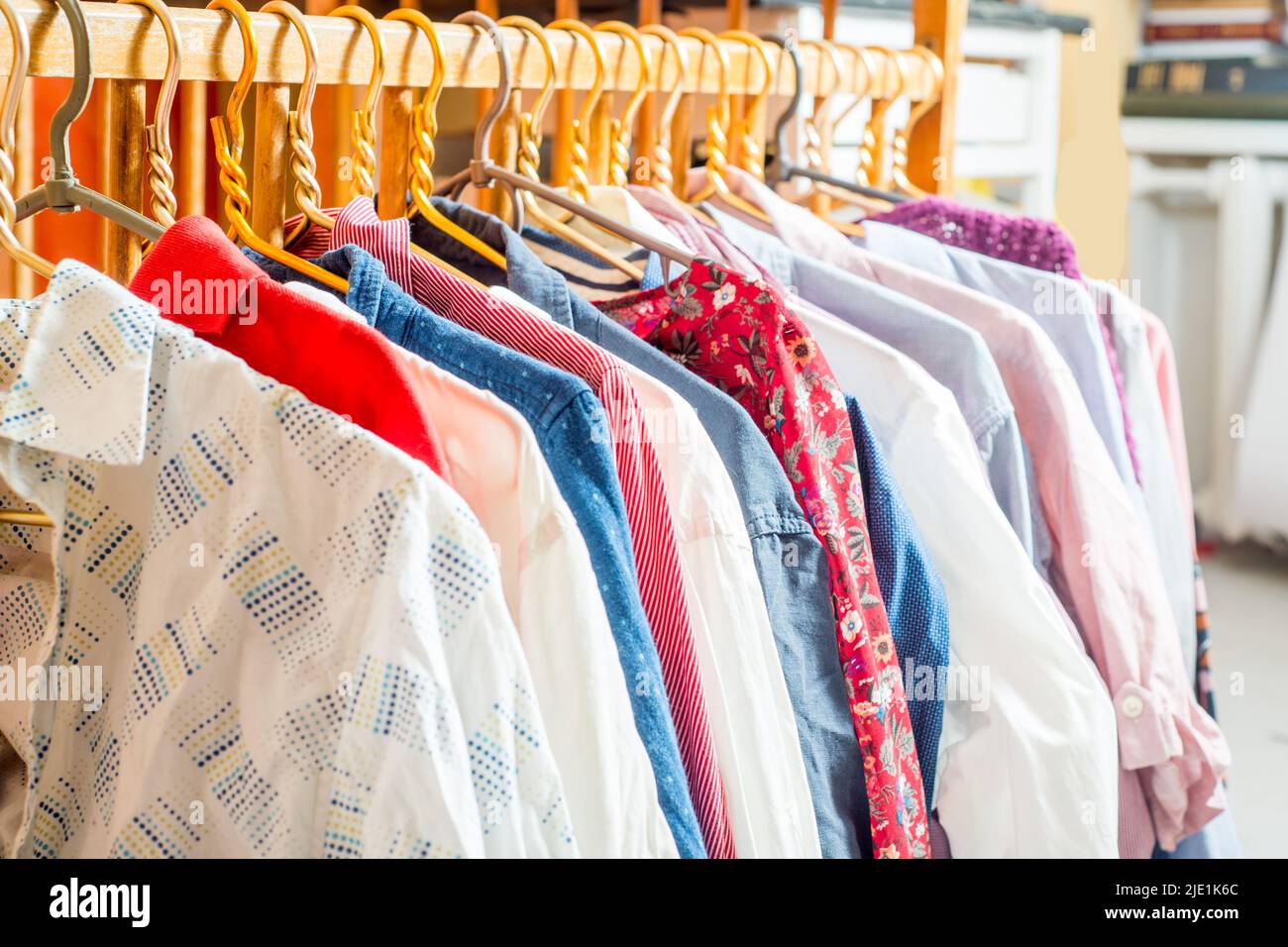 Clothes are hanging on hangers. Lots of clothes for sorting things in