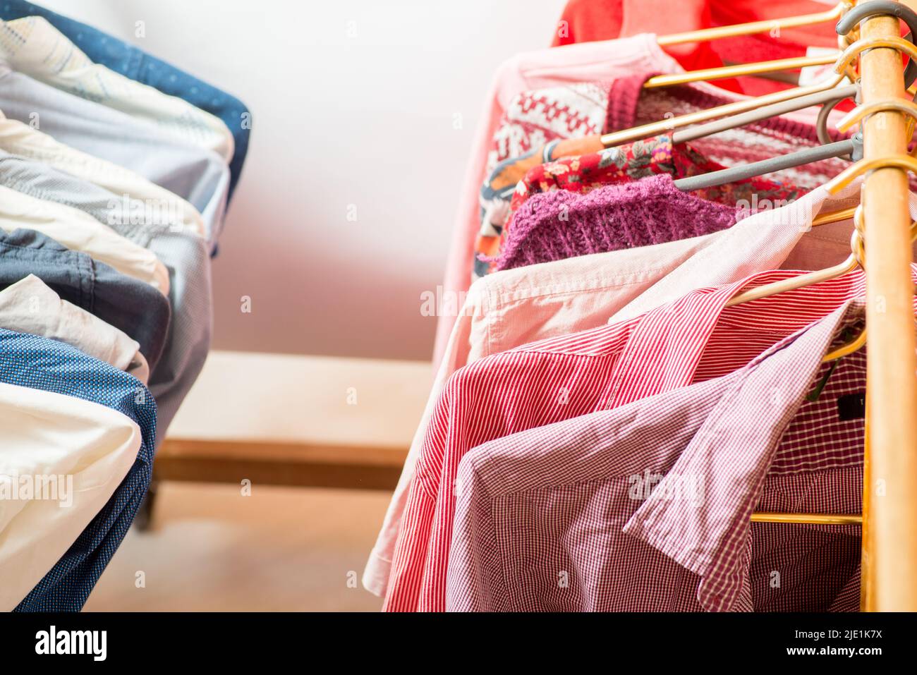 Clothes are hanging on hangers. Many things in the wardrobe on hangers Stock Photo