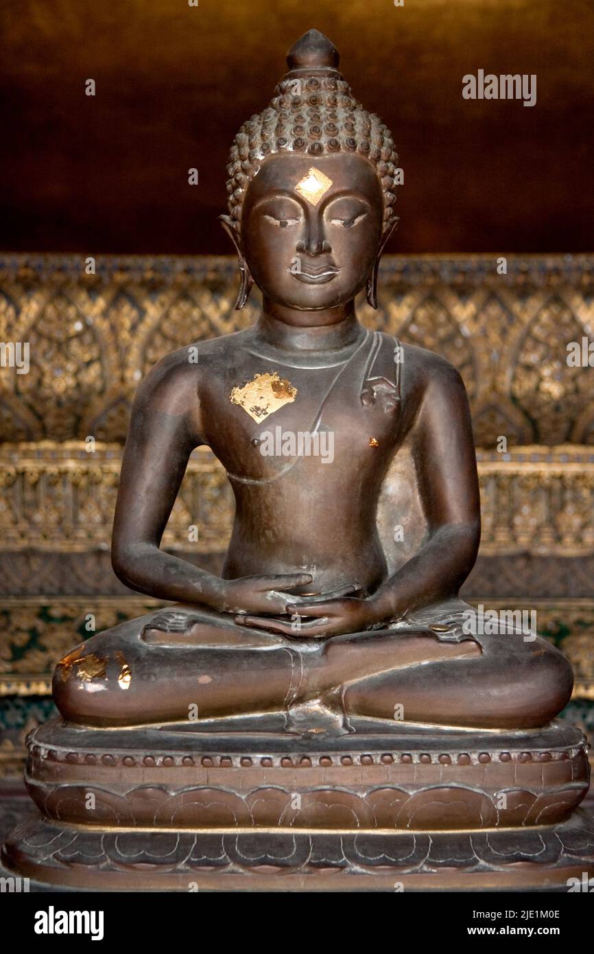 Seated Buddha inside Wat Po, Bangkok, Thailand Stock Photo