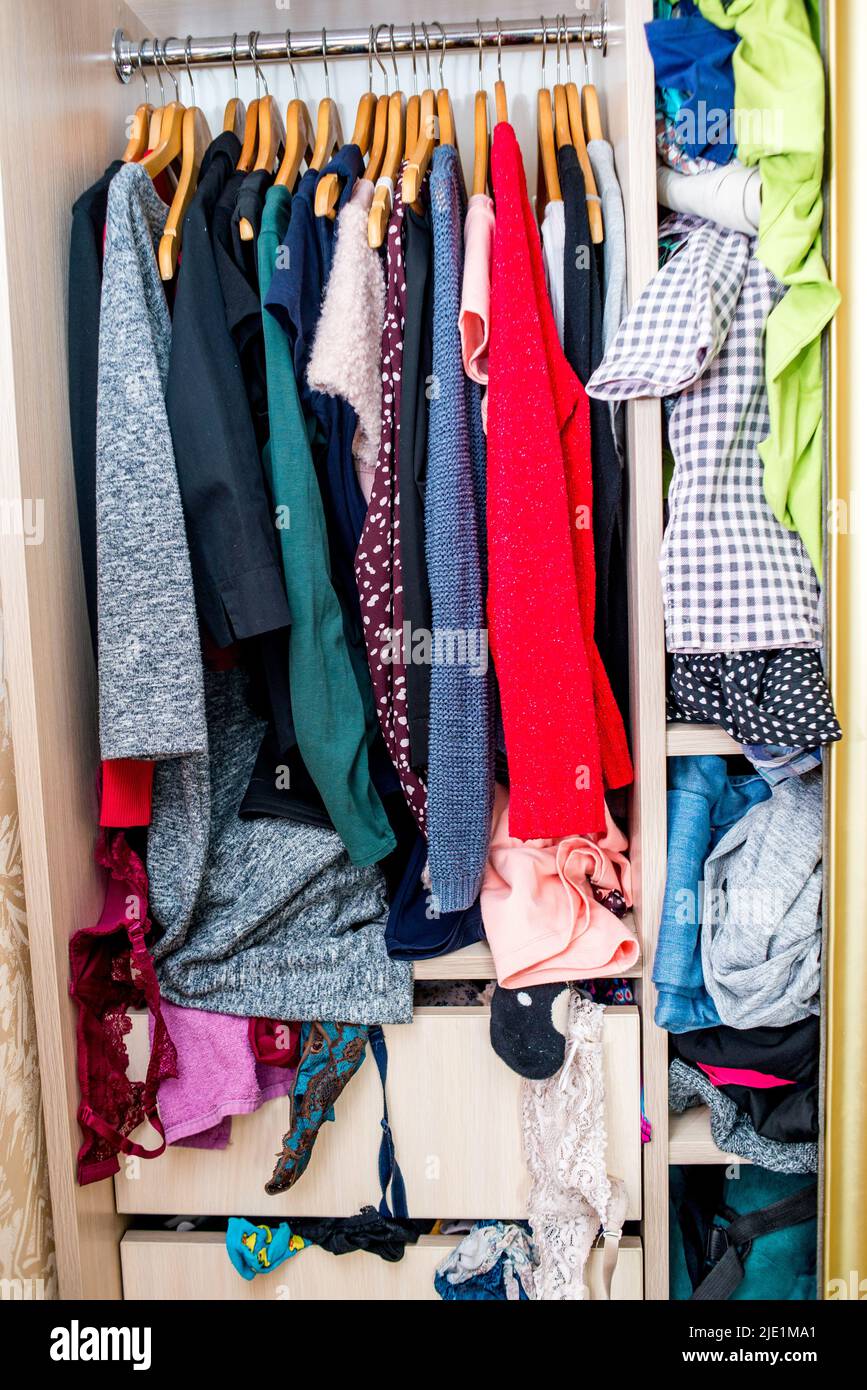 clothes sticking out of the closet. Second hand for recycling Stock