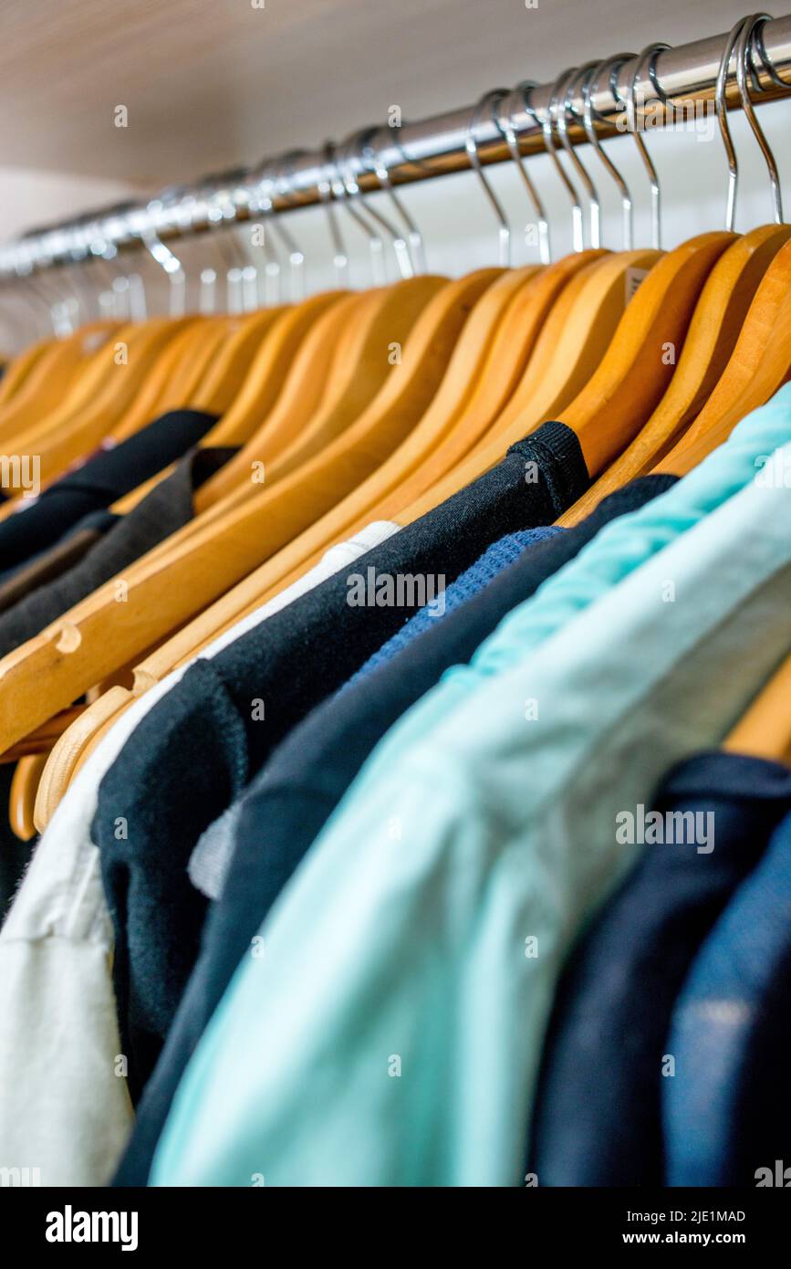 clothes weigh on the shoulders in the closet. Second hand Stock Photo