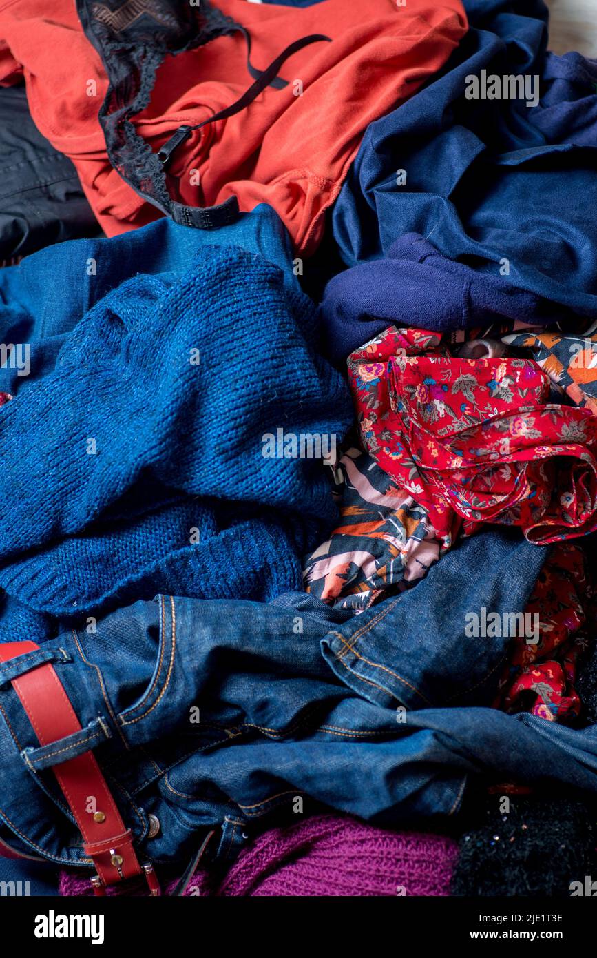 Dump of used clothes. Pile of scattered secondhand clothes on a white background Stock Photo