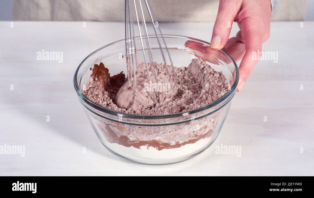 Step by step. Mixing ingredients in a glass mixing bowl to bake