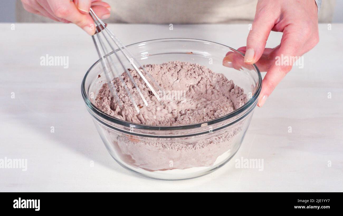 Step by step. Mixing ingredients in a glass mixing bowl to bake