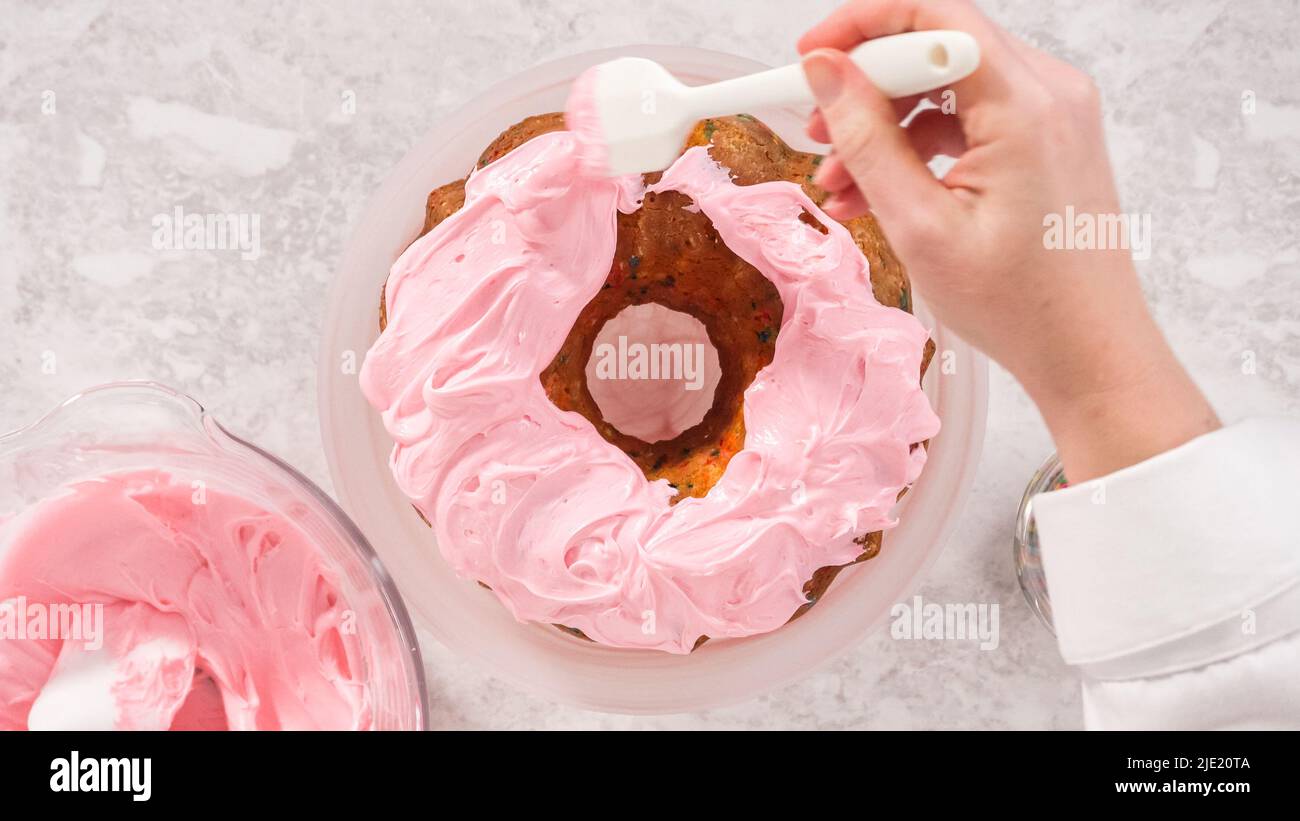 Flat lay. Step by step. Frosting funfetti bunt cake with pink