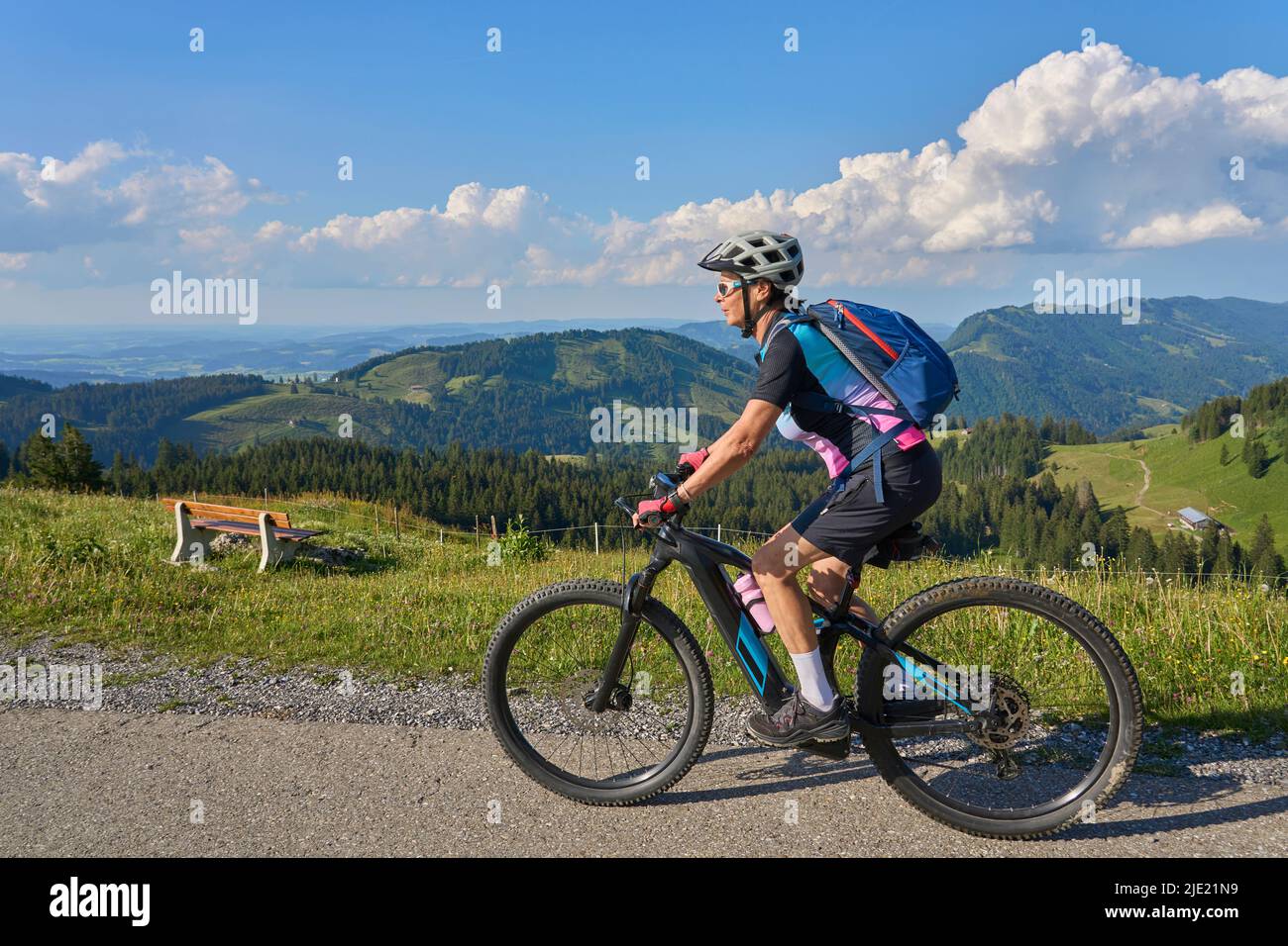 pretty senior woman riding her electric mountain bike in the Allgaeu ...