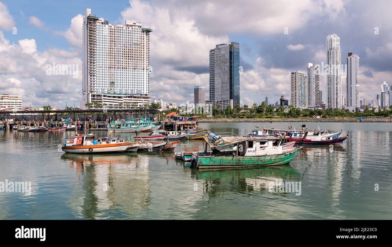Panama City, Panama - October 29, 2021: Fishing boats in Panama Bay, and the skyscrapers by the shores of Panama Bay in Panama City. Stock Photo