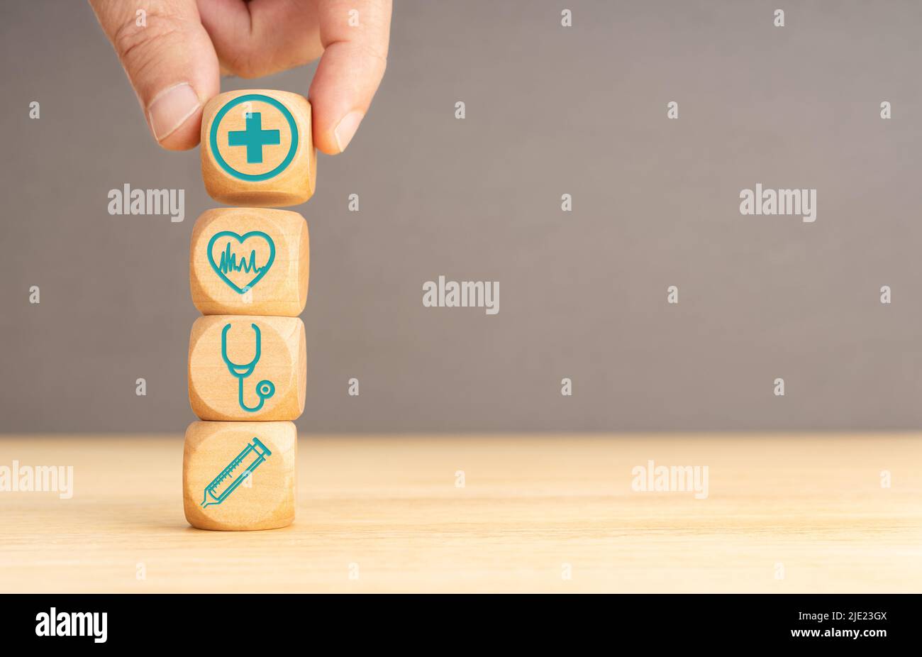 Health insurance concept. Hand hold wooden block with healthcare medical icon. Copy space Stock Photo