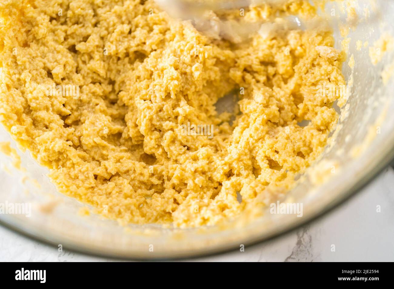 Mixing ingredients with a hand mixer to bake eggnog cookies with a