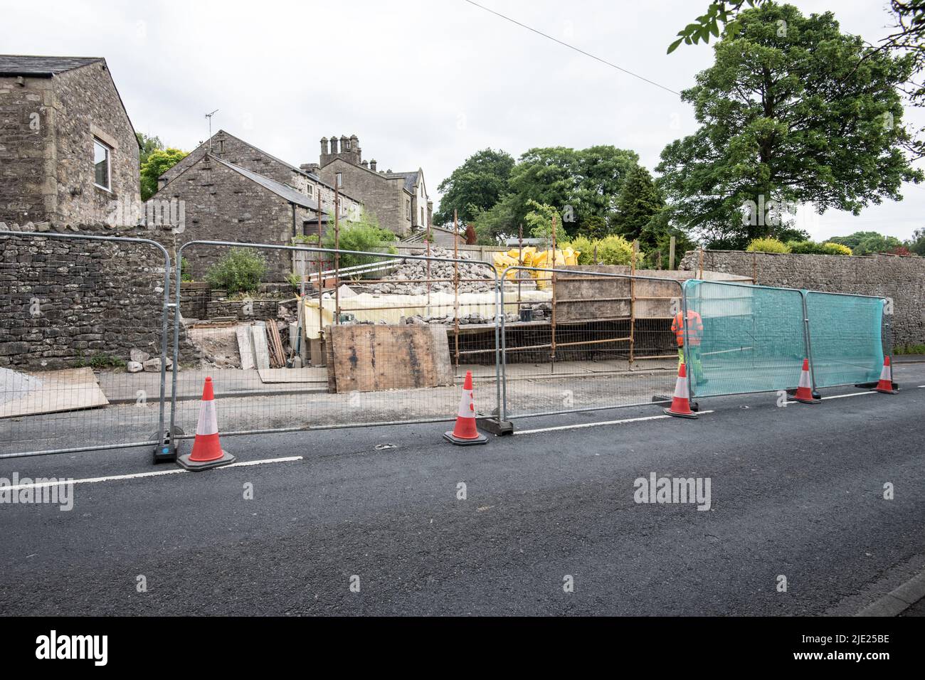 The team crack on with the stonework in front of the blockwork retaining wall. Kayley Hill,Long Preston wall repair proceeding at pace June 24th 2022. Stock Photo