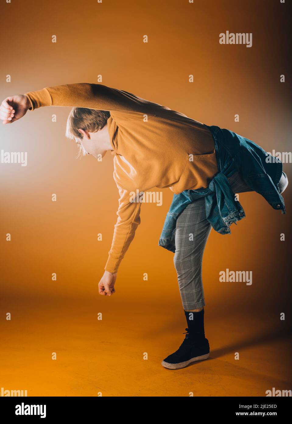 Muscular dance performer practicing dance moves at the studio Stock Photo