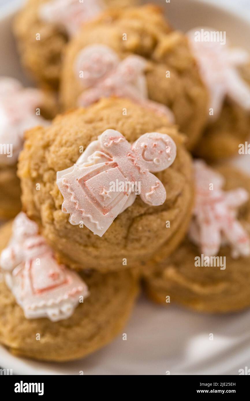 Pile of eggnog cookies with a chocolate gingerbread man in a stack