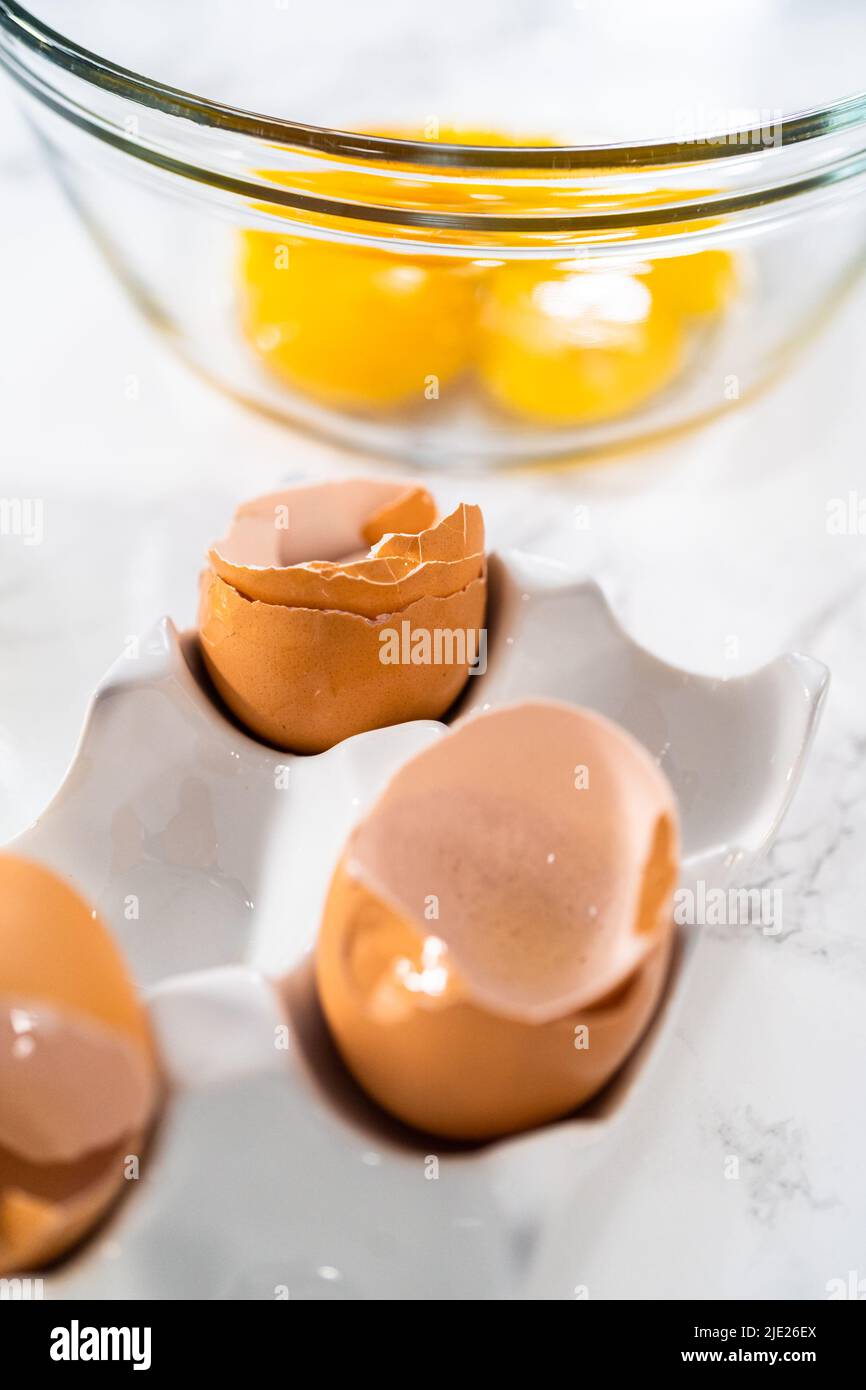 Separating egg whites and yolks to bake meringue cookies Stock Photo Alamy