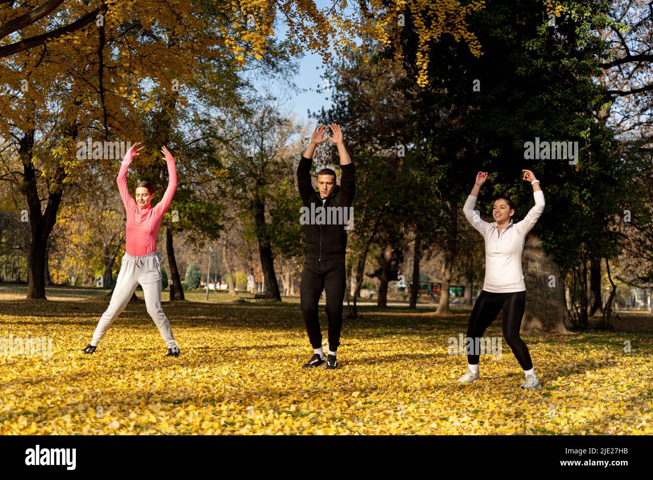 Three amazing and attractive fit friends are doing a jumping jet