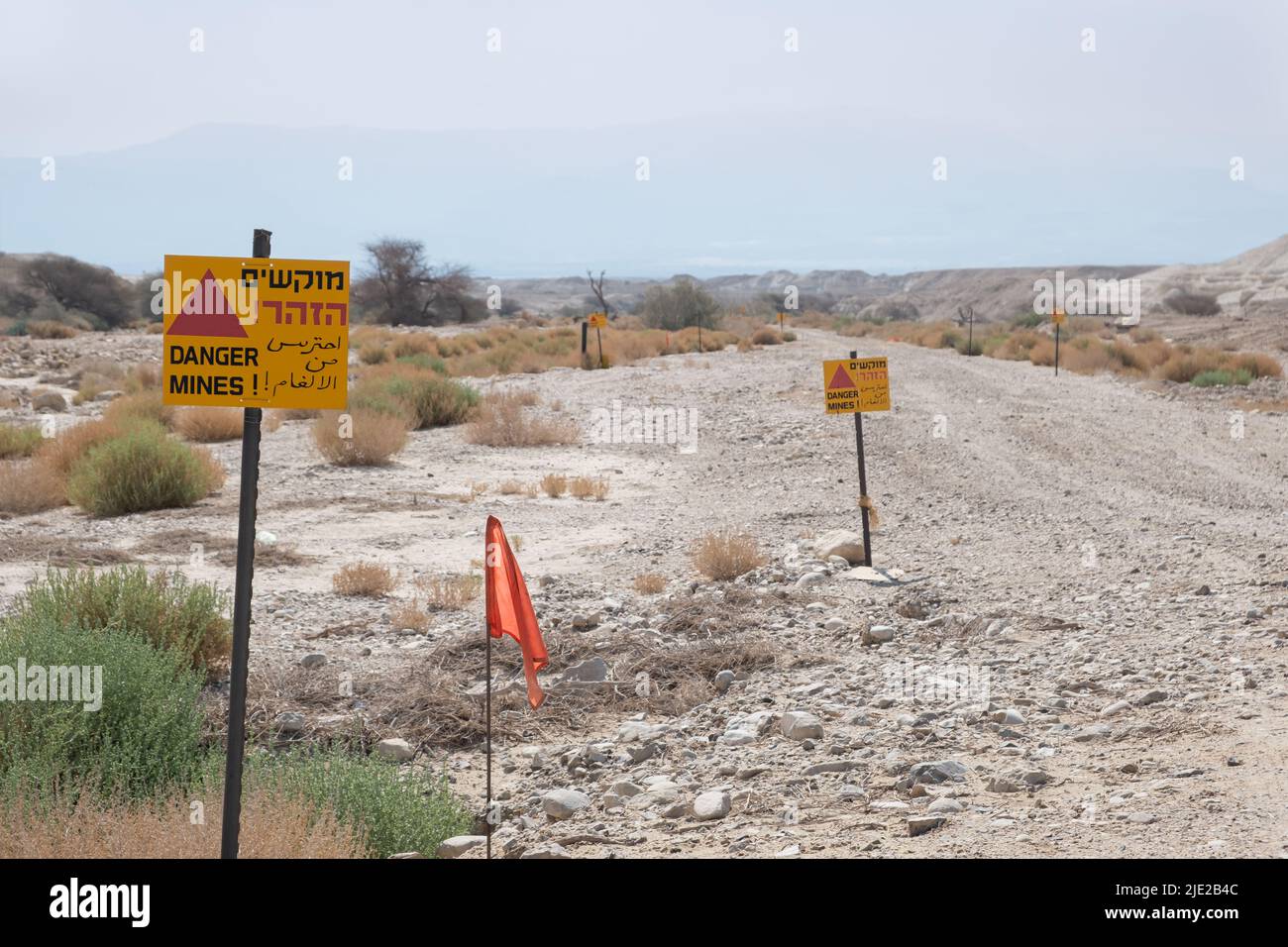 Sign with the text: Warning! Danger Mines in three languages on the ...