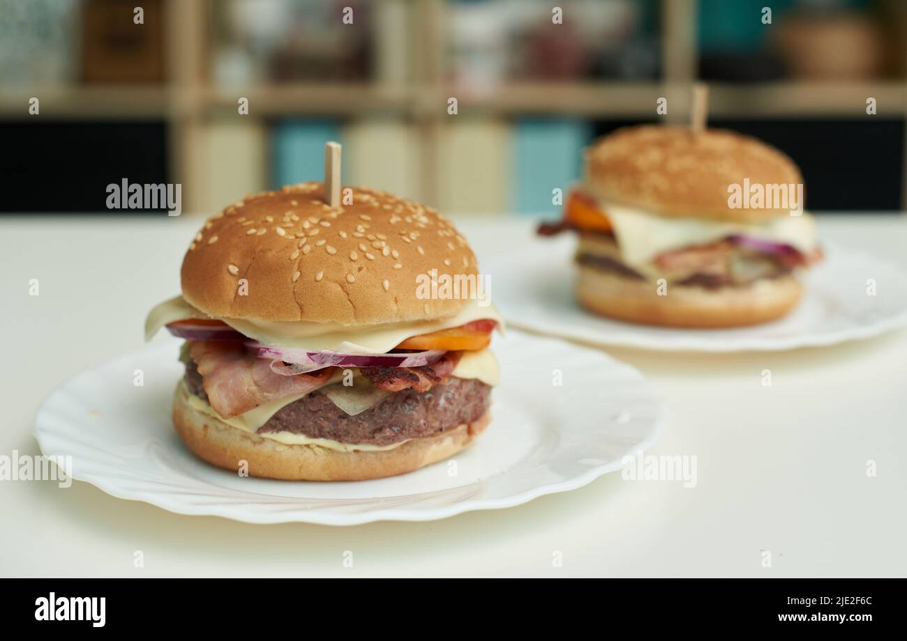 Big and appetizing homemade burgers on the table. Stock Photo