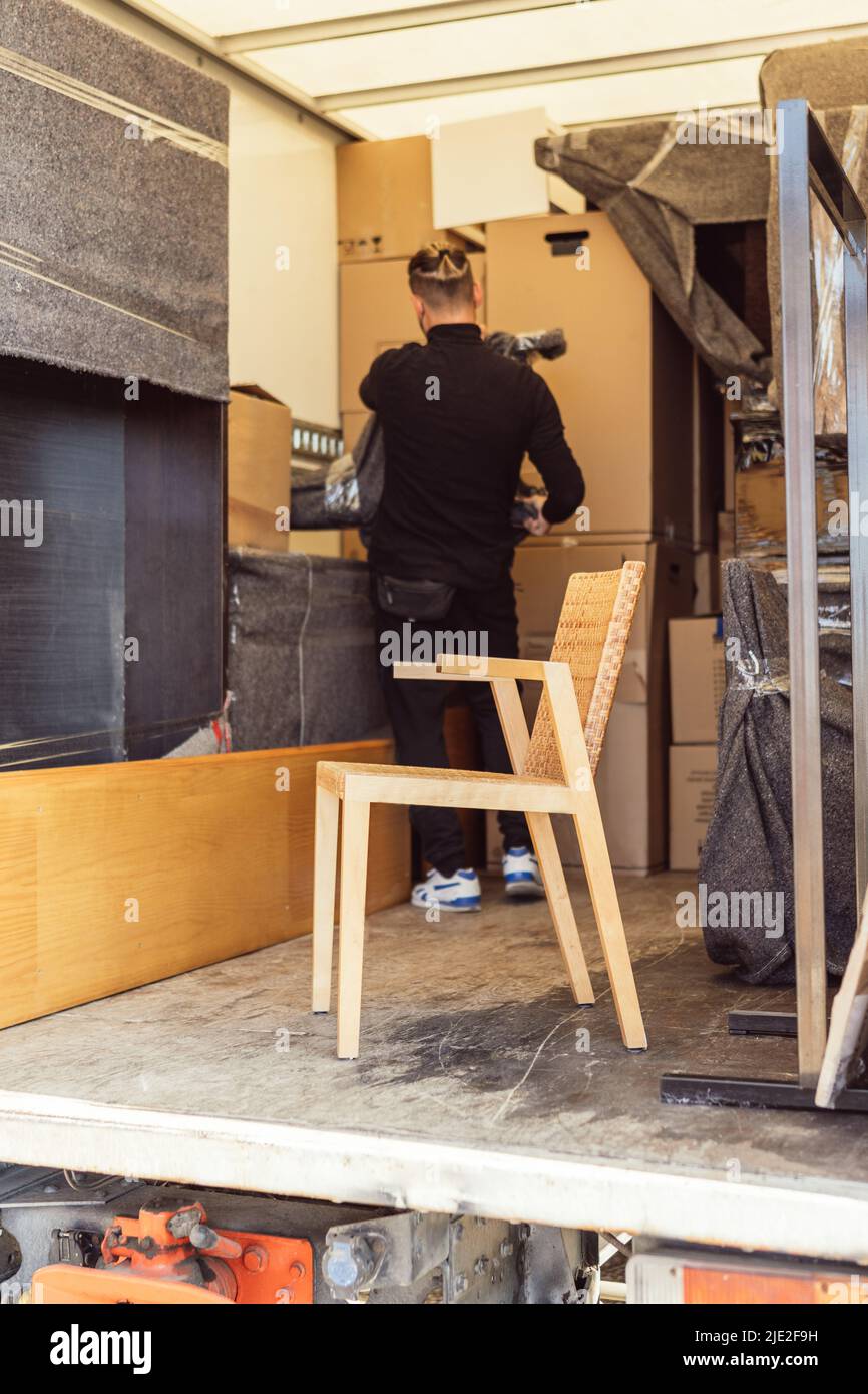 wooden chair inside a moving truck Stock Photo Alamy