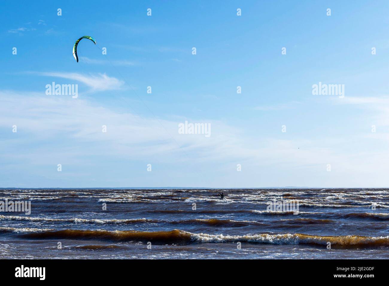 Kitesurfing at sea while performing tricks. freedom, strength, dreams. Stock Photo