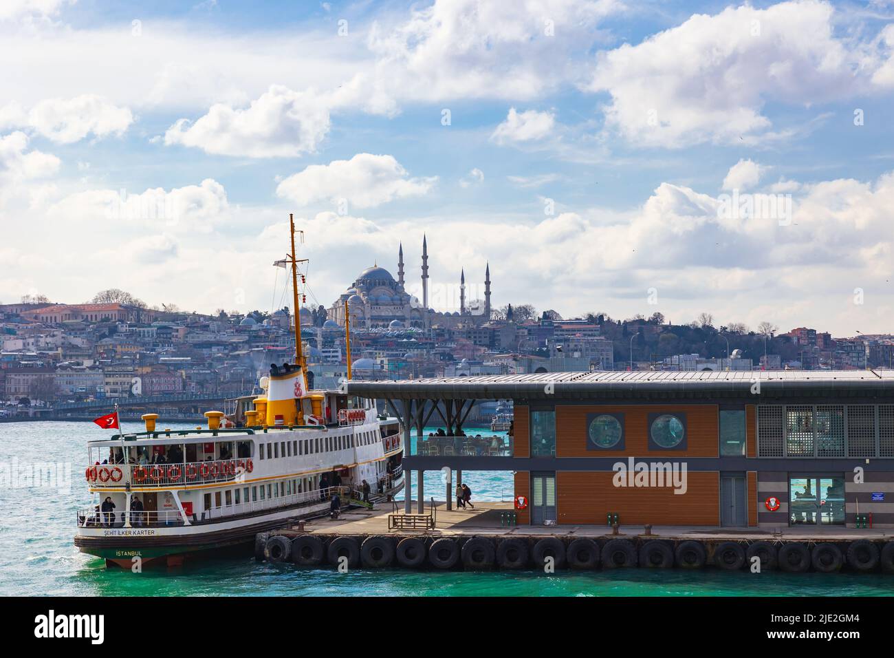 Istanbul view. Karakoy Pier and a ferry with Suleymaniye Mosque on ...