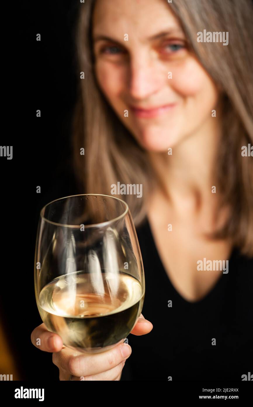 Enjoying the moment. A portrait of a mature woman enjoying a glass of ...