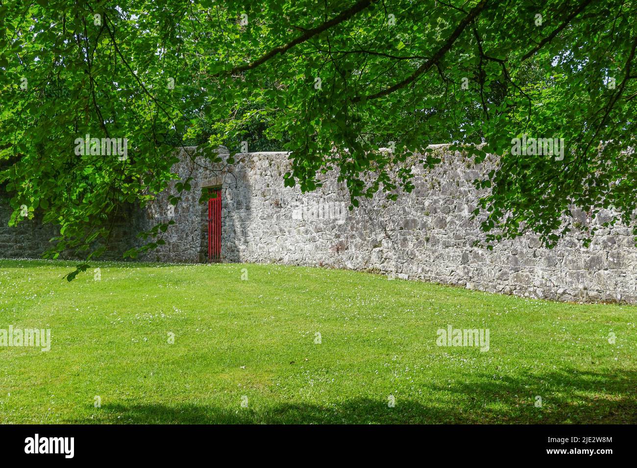 Gort, Co. Galway, Ireland: A red gate in the walled garden at Coole Park. Stock Photo