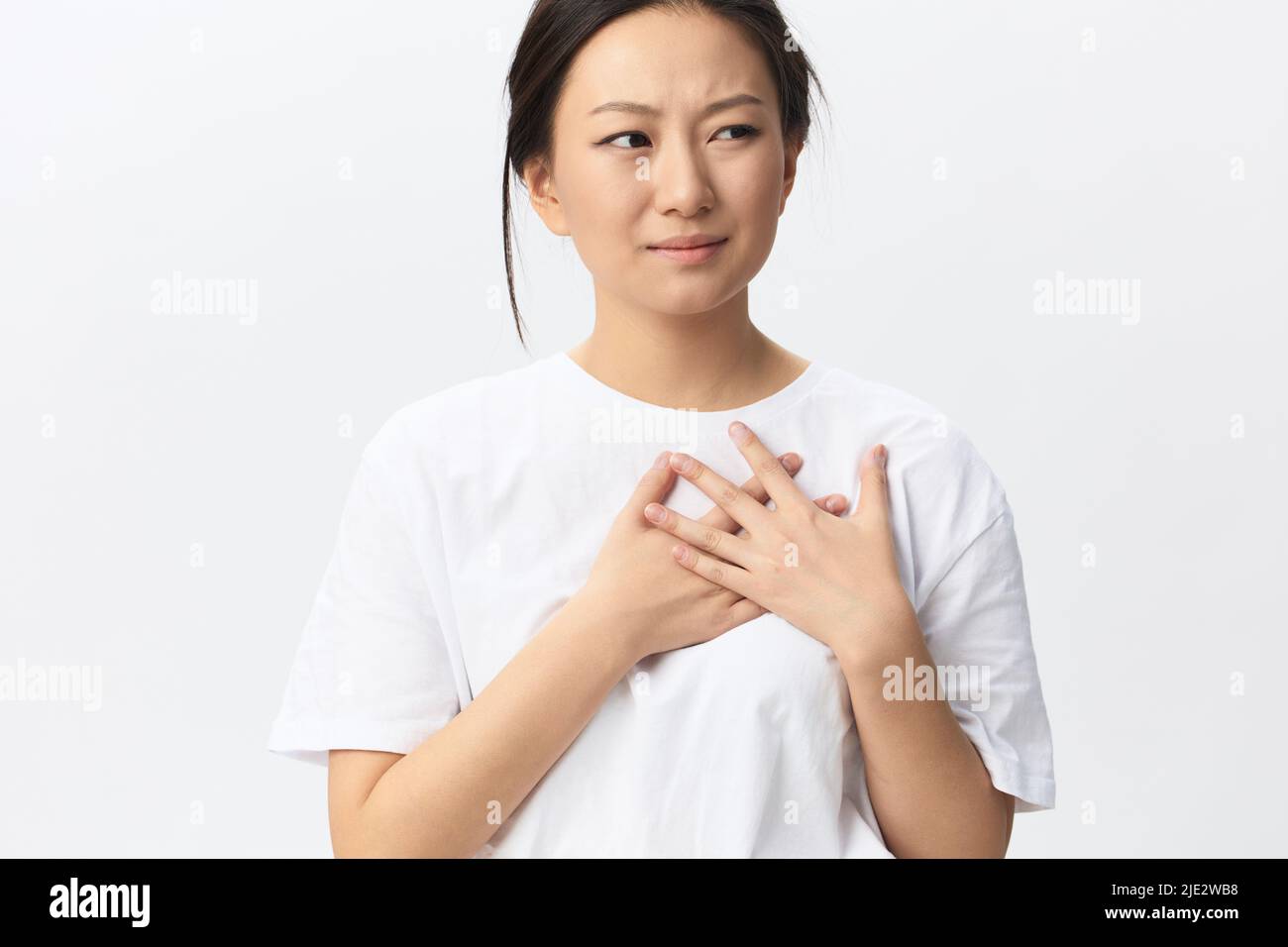 Heart attack. Suffering from pain tanned beautiful young Asian woman