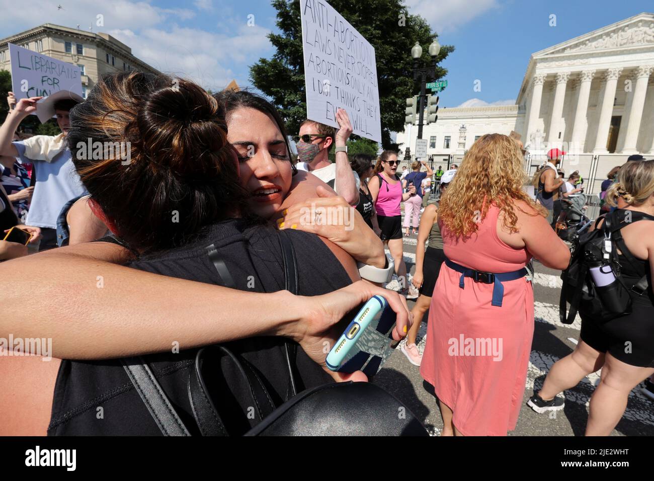 MJ Flores, a San Antonio Texas woman who had an abortion in Texas, cries while hugging Daniela Diaz, a friend from Venezuela who had an abortion in Washington, DC, during a protest outside the United States Supreme Court as the court rules in the Dobbs v Women's Health Organization abortion case, overturning the landmark Roe v Wade abortion decision, in Washington, DC, U.S., June 24, 2022. REUTERS/Jim Bourg Stock Photo