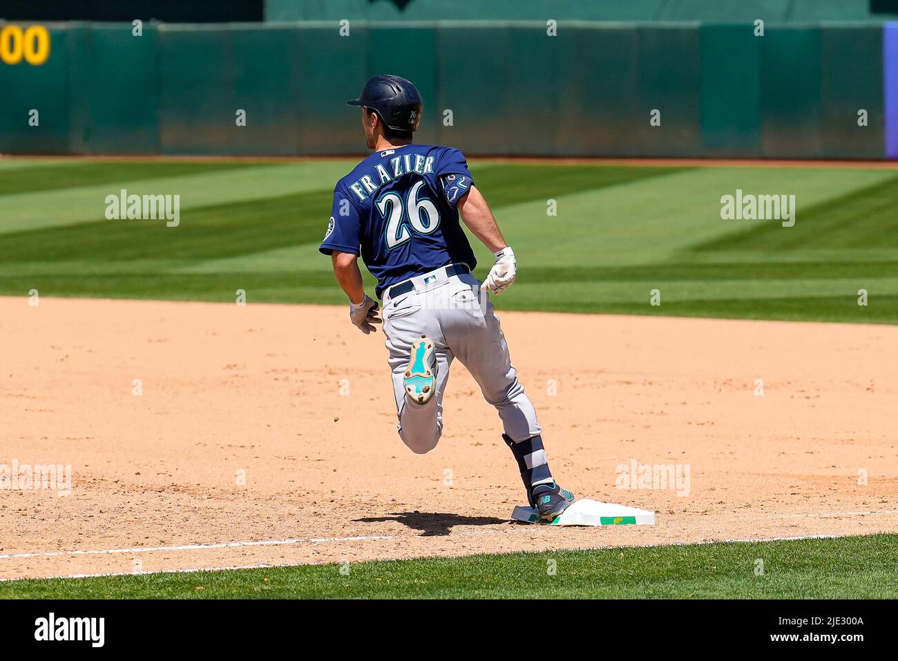 Seattle Mariners Infielder  Adam Frazier (26) runs to first base during an MLB game between SeattleMariners and Oakland Athletics at the RingCentral C Stock Photo
