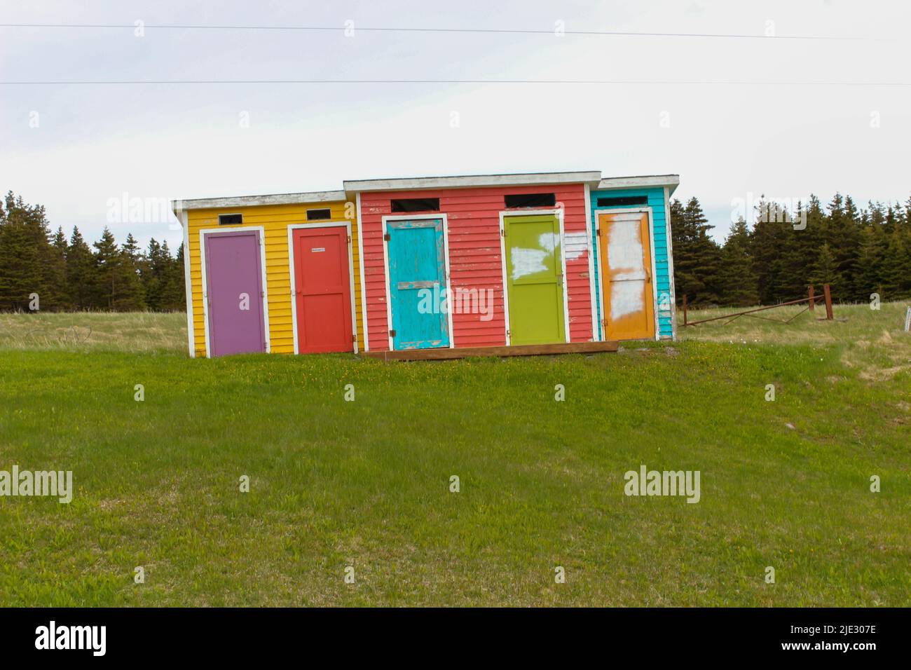 Colourful outhouses along a hike in Cows Head Newfoundland. Interesting sight seeing Stock Photo