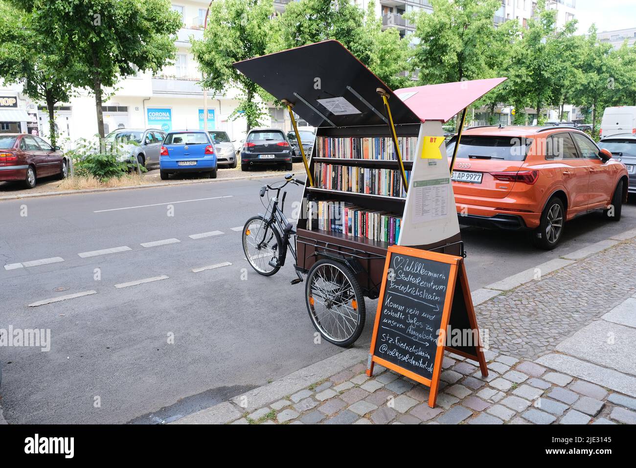 Berlin, Germany, June 24, 2022, book exchange bike in front of the Friedrichshain district center. Stock Photo