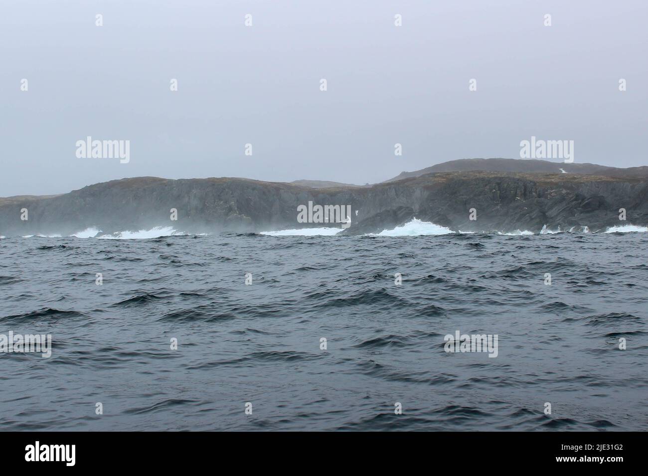 Wave crashing against small iceberg bit floating in sea Stock Photo - Alamy