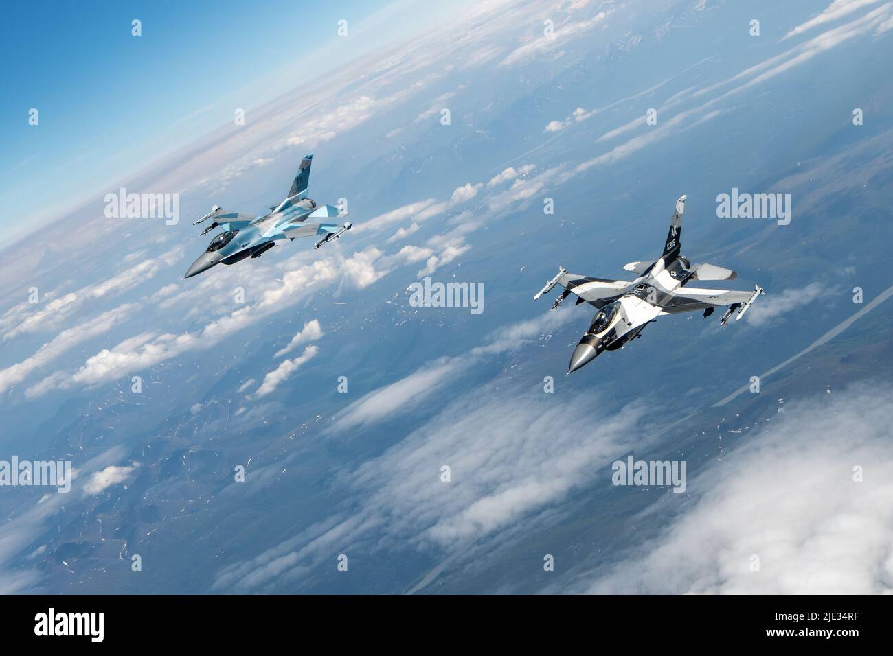 U.S. Air Force F-16 Fighting Falcons, both assigned to the 18th Aggressor Squadron, Eielson Air Force Base, fly above the Joint Pacific Alaska Range Complex during a training sortie for RED FLAG-Alaska 22-2, June 22, 2022. The 18th Aggressor Squadron supports RFA by sharing its knowledge of adversarial tactics, techniques, and procedures to participating units, ensuring the United States and its allies receive the best air combat training possible. (U.S. Air Force photo by Senior Airman Patrick Sullivan) Stock Photo