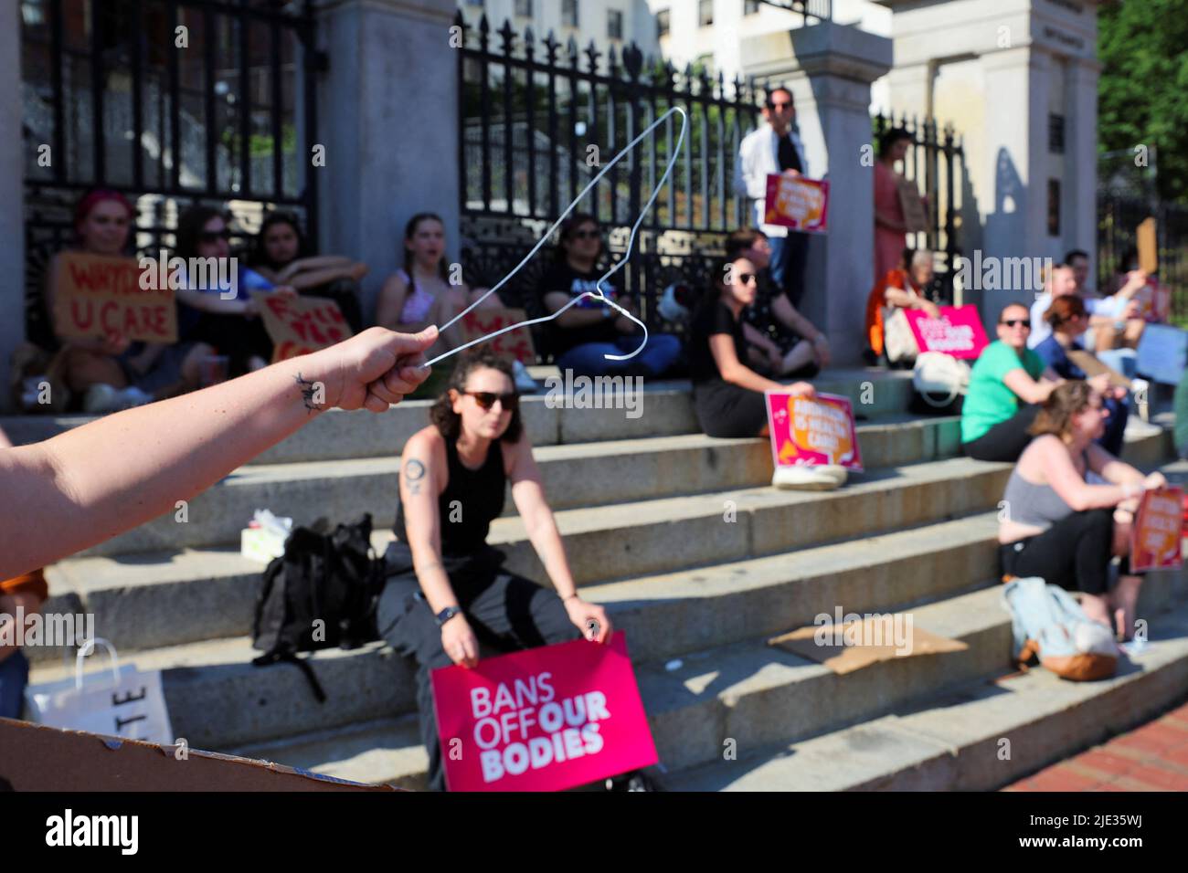 A demonstrador holds a hook as abortion rights protesters demonstrate after the U.S. Supreme Court ruled in the Dobbs v Women?s Health Organization abortion case, overturning the landmark Roe v Wade abortion decision in Boston, Massachusetts, U.S., June 24, 2022. REUTERS/Brian Snyder Stock Photo