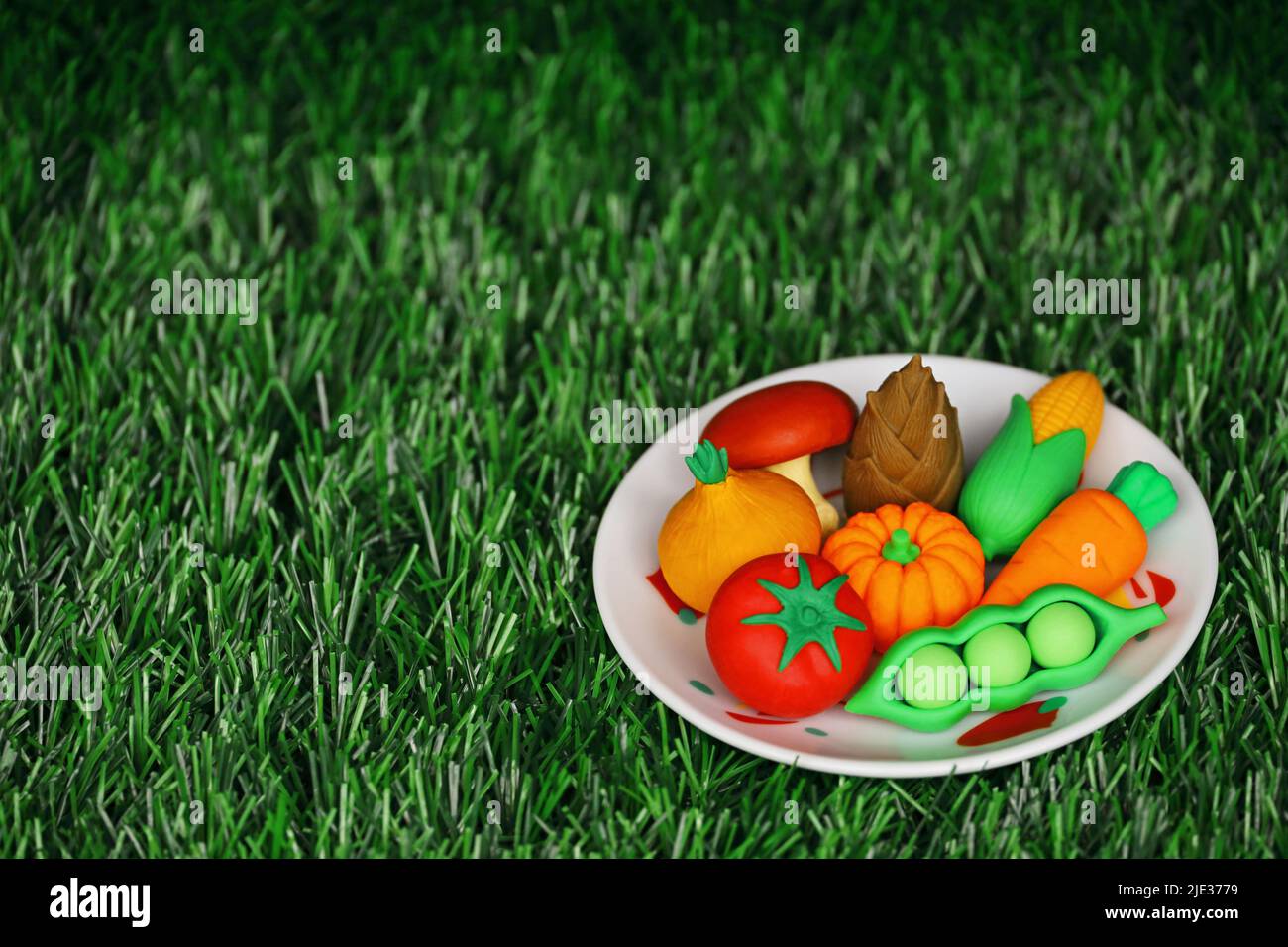 Miniature model of colorful vegetables arrangement on a white plate Stock Photo