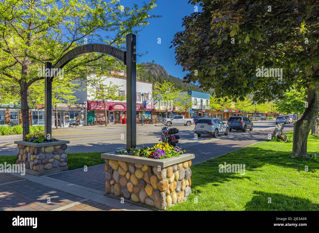 A lakeside road fringing Lake Okanagan in Peachland BC Canada. Beautiful summer park in sunny morning in the town Stock Photo