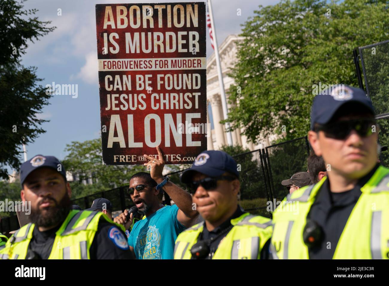 Washington, USA. 24th June, 2022. Police defend an anti-abortion demonstrator from protesters in opposition outside the Supreme Court in Washington, DC Friday, June 24, 2022. The Supreme Court overturned Roe v, Wade eliminating the right to abortion in the U.S. (Photo by Chris Kleponis/Sipa USA) Credit: Sipa USA/Alamy Live News Stock Photo