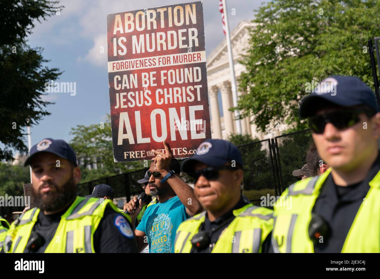 Washington, USA. 24th June, 2022. Police defend an anti-abortion demonstrator from protesters in opposition outside the Supreme Court in Washington, DC Friday, June 24, 2022. The Supreme Court overturned Roe v, Wade eliminating the right to abortion in the U.S. (Photo by Chris Kleponis/Sipa USA) Credit: Sipa USA/Alamy Live News Stock Photo