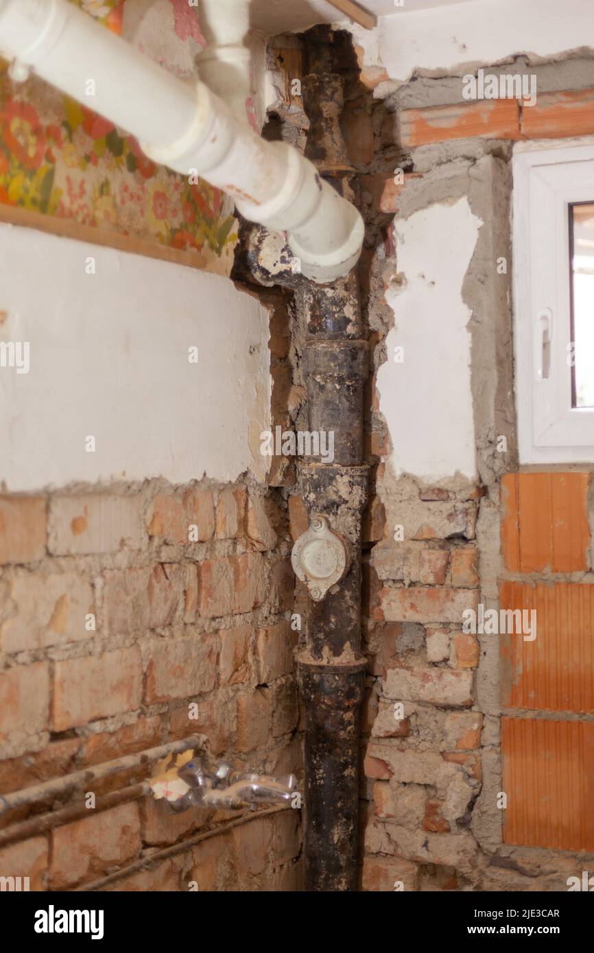 Old Defective Sewage Pipe Exposed In An Old Building Stock Photo