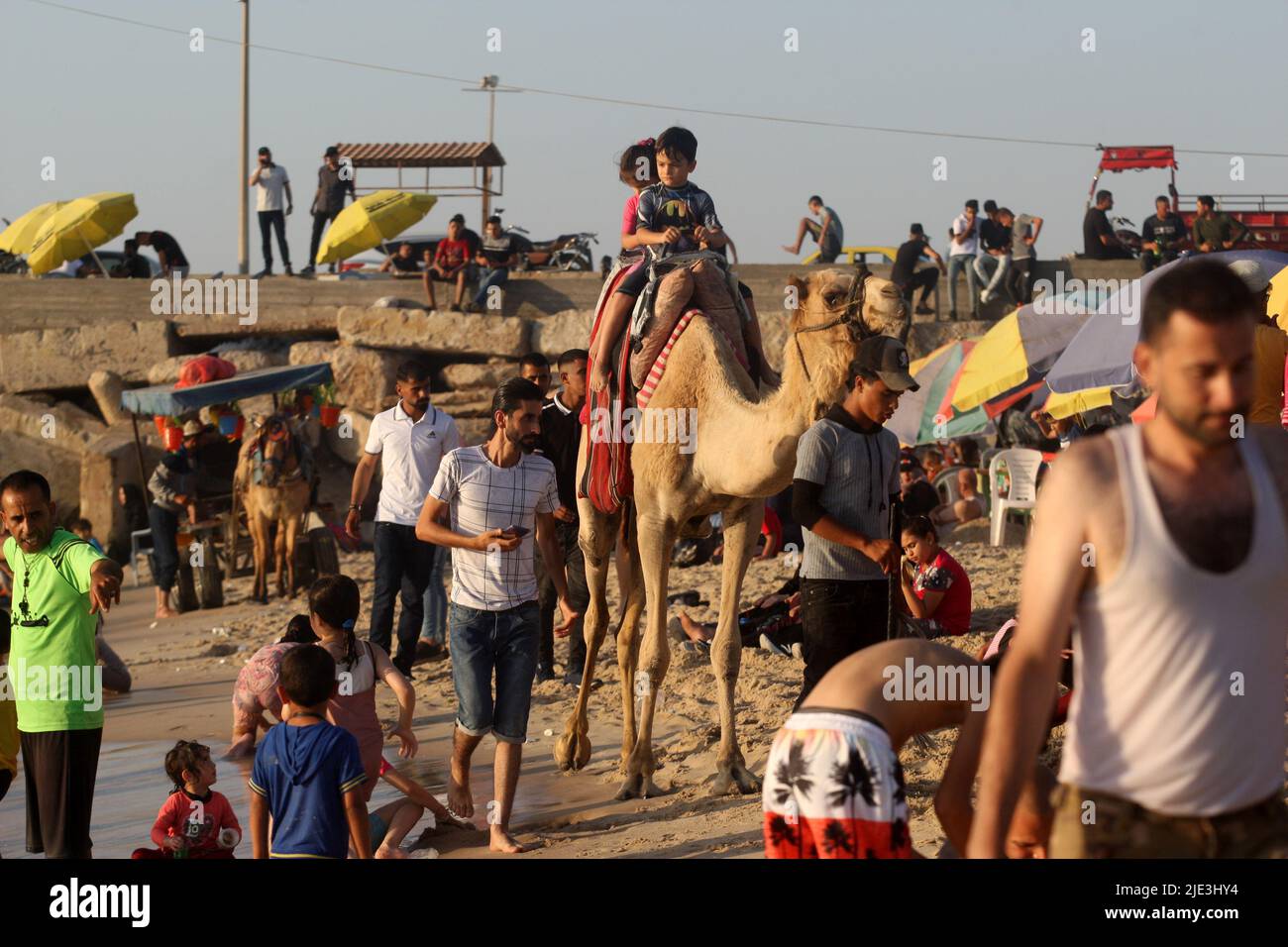 Gaza, Gaza. 24th June, 2022. Palestinian children ride a camel along the shores in Gaza City on Friday, June 24, 2022. Photo by Ismael Mohamad/UPI Credit: UPI/Alamy Live News Stock Photo