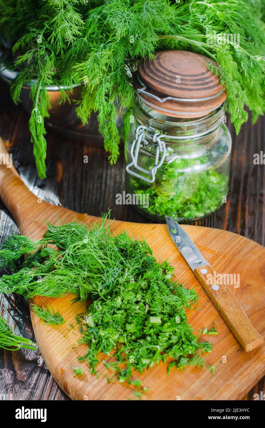 Green young dill sliced on a kitchen board. Freshly cut greens Stock Photo