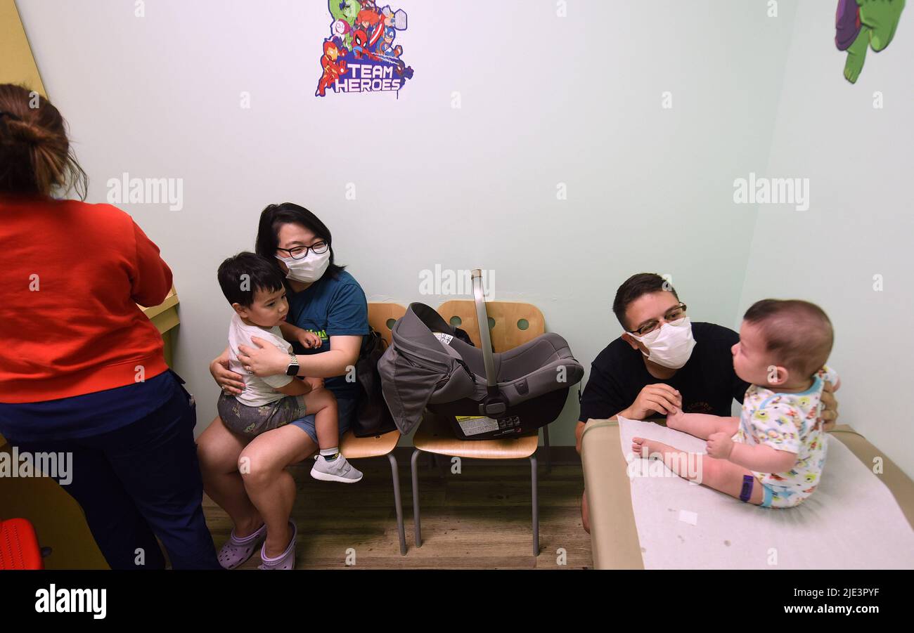 Yingxue Ren and Adrian Perez comfort their children, ages 2 years and 6 ...