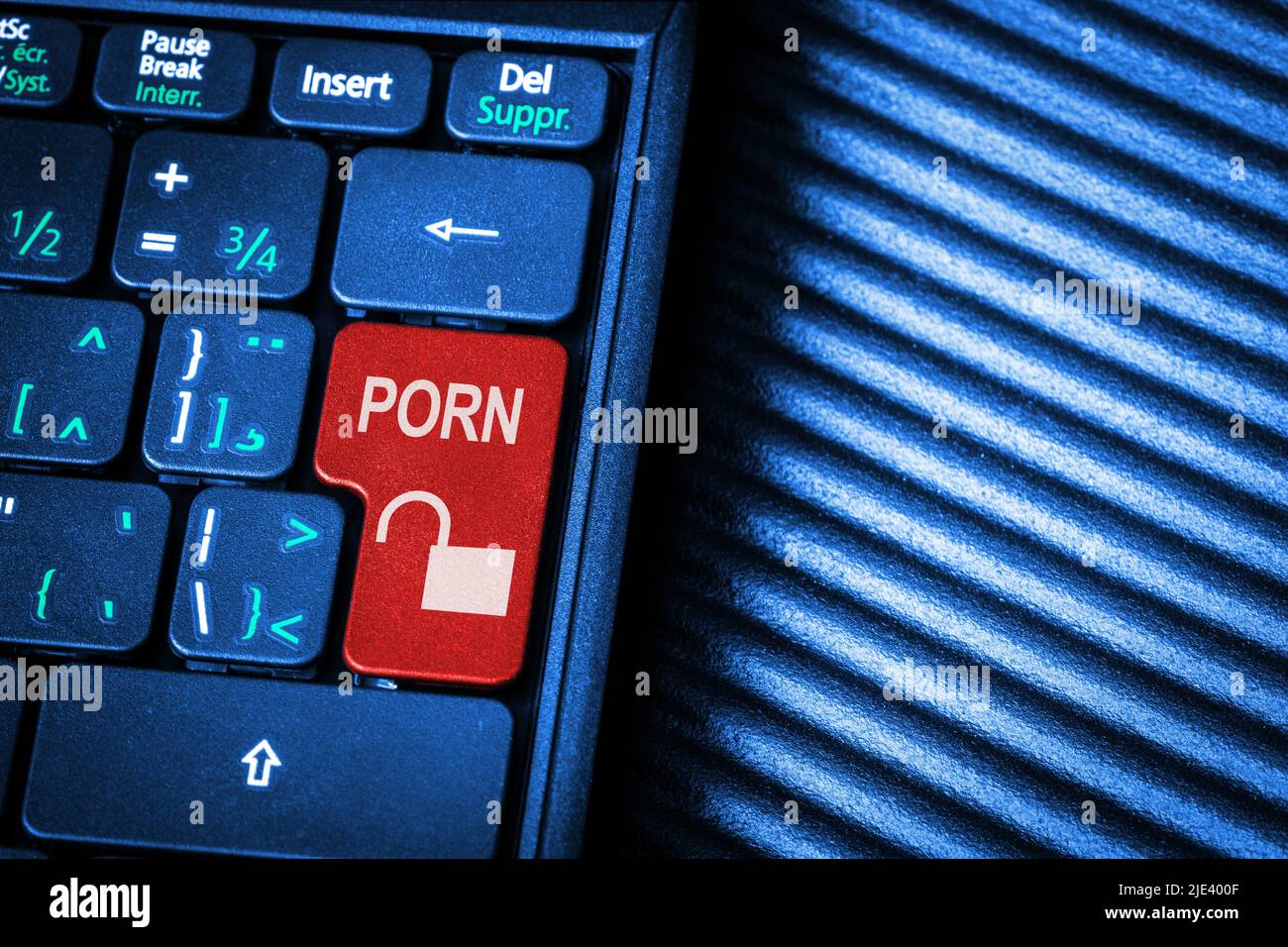Surfing the Internet unlocking pornography concept showing red computer key marked Porn with copy space. Stock Photo
