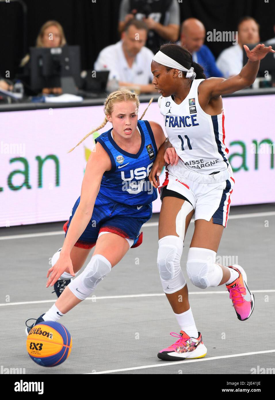 Antwerp, Belgium. 24th June, 2022. Hailey Van Lith (L) of the United States dribbles under the defense of Myriam Djekoundade of France during the FIBA 3X3 World Cup women's pool round match between the United States and France in Antwerp, Belgium, June 24, 2022. Credit: Ren Pengfei/Xinhua/Alamy Live News Stock Photo