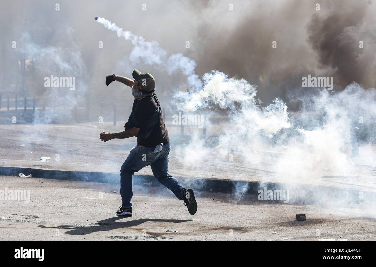 Quito, Ecuador. 23rd June, 2022. A protester throws a teargas bomb ...