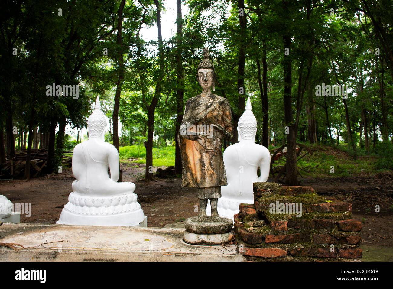 Ancient broken buddha statue in antique ruins building for thai people