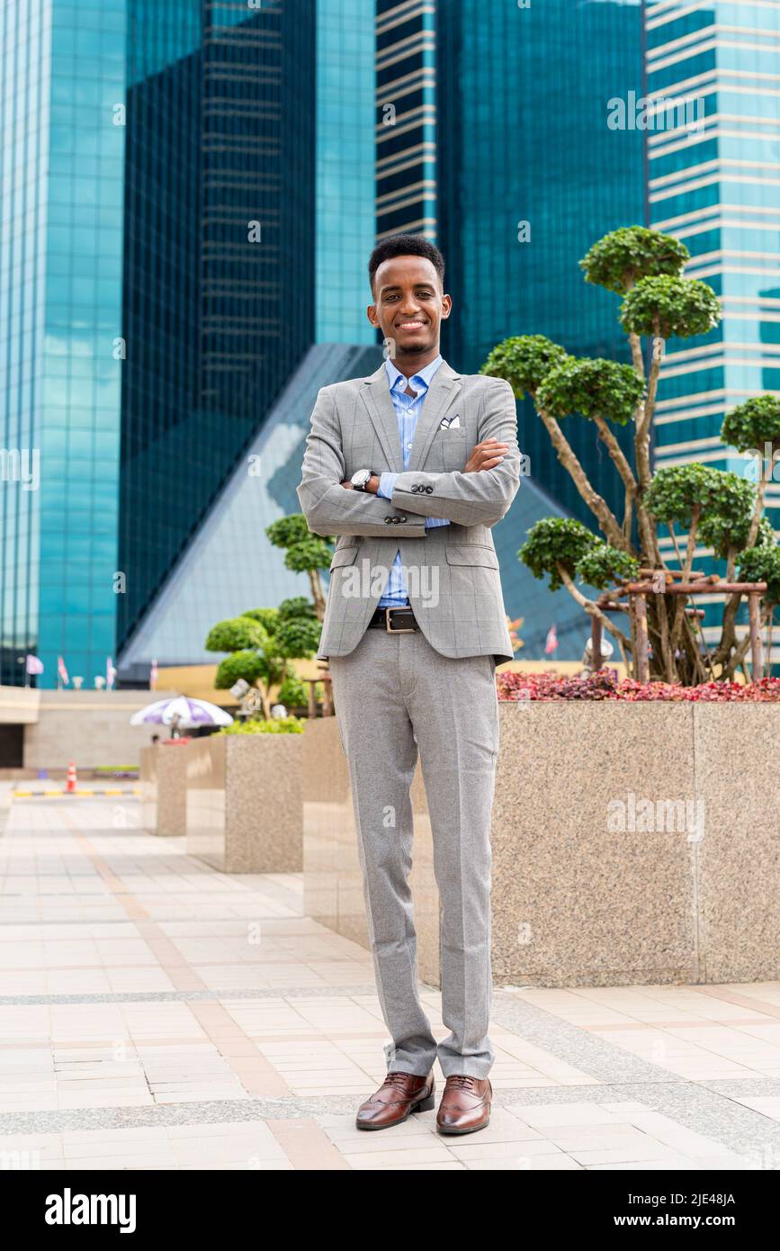 Handsome young black businessman outdoors in city Stock Photo