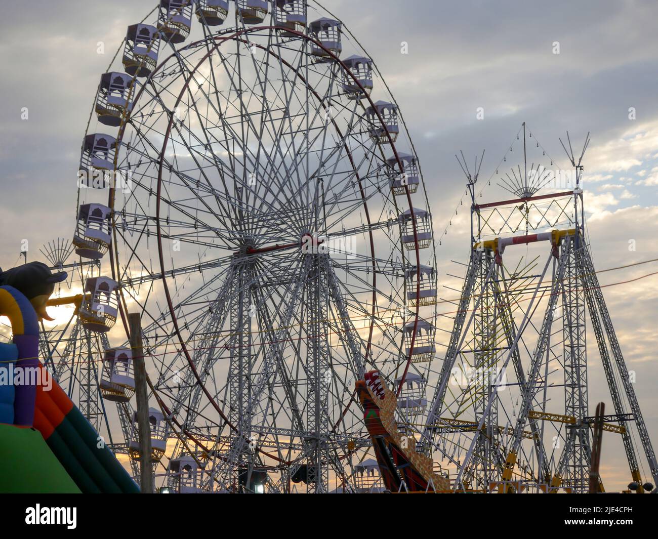 Giant wheel carnival ride or Ferris wheel flyer ride in Indian village fair ground at night Stock Photo