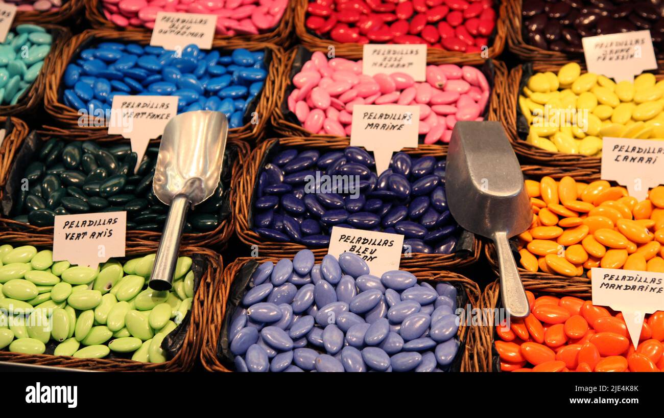Various flavored 'Peladillas' sugared almonds for sale in a market in Barcelona Spain. Stock Photo
